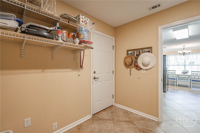 124 Jennifer Cir, Rincon, GA 31326 - laundry room with a chandelier and light tile patterned flooring