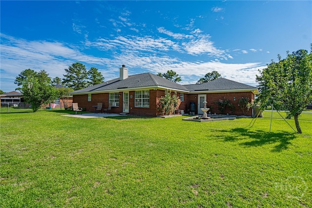 124 Jennifer Cir, Rincon, GA 31326 - rear view of house with a patio, a chimney, and brick siding