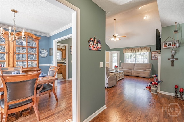 124 Jennifer Cir, Rincon, GA 31326 - dining space with ceiling fan, a textured ceiling, a chandelier, wood finished floors, and lofted ceiling