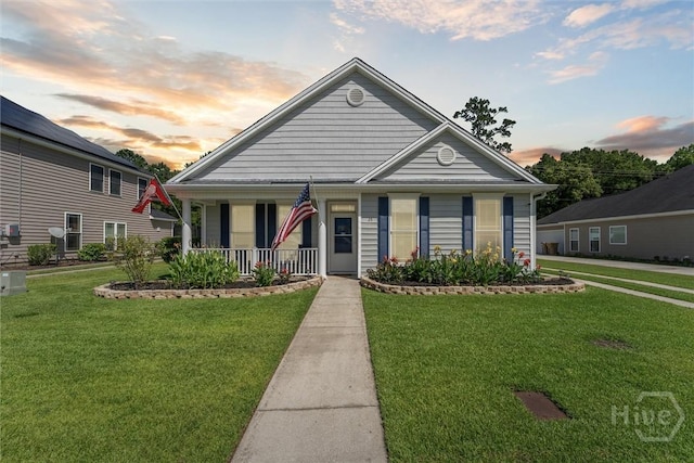 25 Savannah Ln, Richmond Hill, GA 31324 - view of front facade featuring covered porch and a lawn