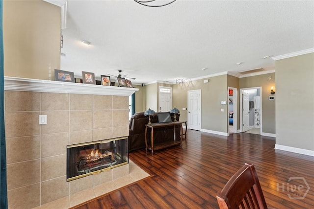 25 Savannah Ln, Richmond Hill, GA 31324 - living area featuring ceiling fan, hardwood / wood-style floors, crown molding, and a tiled fireplace