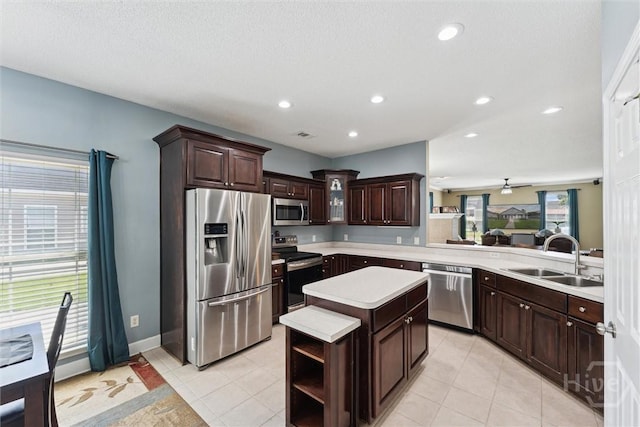 25 Savannah Ln, Richmond Hill, GA 31324 - kitchen featuring stainless steel appliances, light countertops, dark brown cabinetry, a center island, and recessed lighting