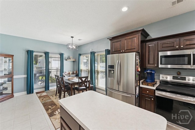 25 Savannah Ln, Richmond Hill, GA 31324 - kitchen featuring appliances with stainless steel finishes, light countertops, a chandelier, dark brown cabinetry, and a textured ceiling