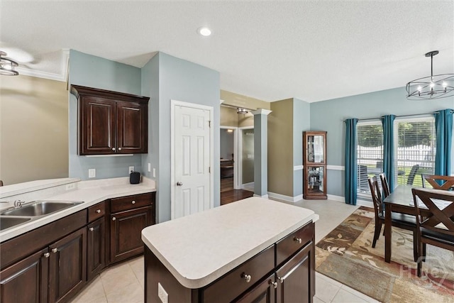 25 Savannah Ln, Richmond Hill, GA 31324 - kitchen featuring light countertops, light tile patterned floors, dark brown cabinets, a textured ceiling, and decorative light fixtures
