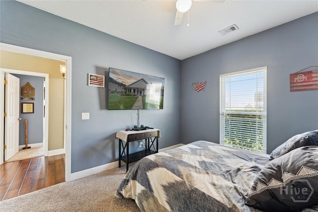 25 Savannah Ln, Richmond Hill, GA 31324 - carpeted bedroom with a ceiling fan and wood finished floors