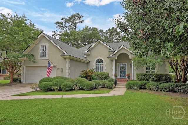 144 Summer Winds Dr, Savannah, GA 31410 - traditional-style home with stucco siding, a front yard, an attached garage, driveway, and roof with shingles