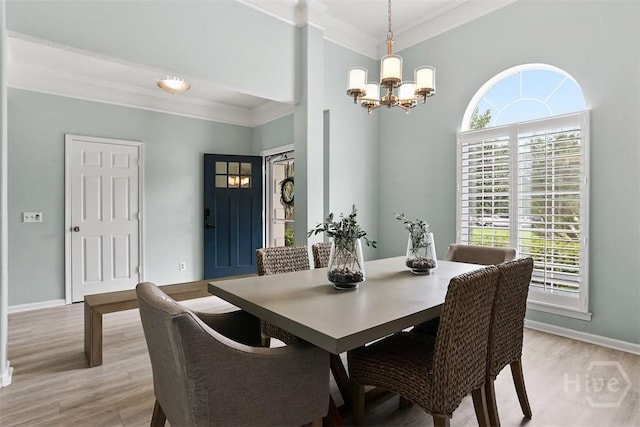 144 Summer Winds Dr, Savannah, GA 31410 - dining space featuring a chandelier, light wood-type flooring, ornamental molding, and healthy amount of natural light