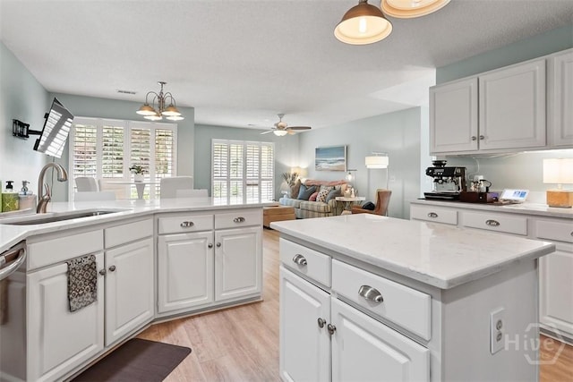 144 Summer Winds Dr, Savannah, GA 31410 - kitchen featuring stainless steel dishwasher, light wood-style flooring, a ceiling fan, and white cabinets
