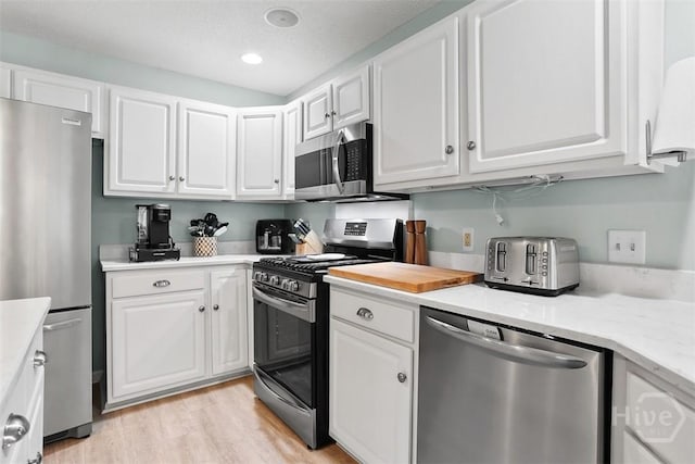 144 Summer Winds Dr, Savannah, GA 31410 - kitchen with stainless steel appliances, light countertops, white cabinetry, light wood-style flooring, and recessed lighting