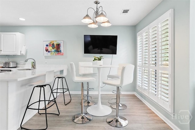 144 Summer Winds Dr, Savannah, GA 31410 - dining room featuring light wood-style floors, recessed lighting, and a chandelier