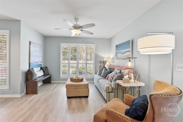 144 Summer Winds Dr, Savannah, GA 31410 - living area featuring light wood finished floors, plenty of natural light, a ceiling fan, and a textured ceiling