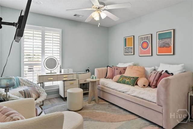 144 Summer Winds Dr, Savannah, GA 31410 - living area featuring a ceiling fan, healthy amount of natural light, wood finished floors, and a textured ceiling