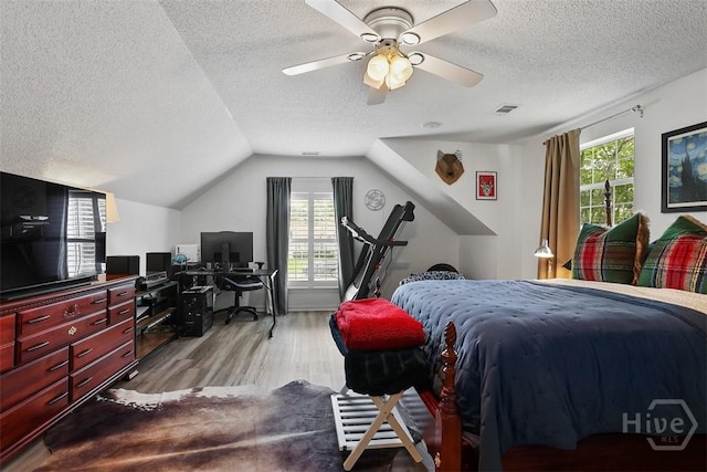 144 Summer Winds Dr, Savannah, GA 31410 - bedroom featuring a textured ceiling, wood finished floors, an office area, multiple windows, and vaulted ceiling