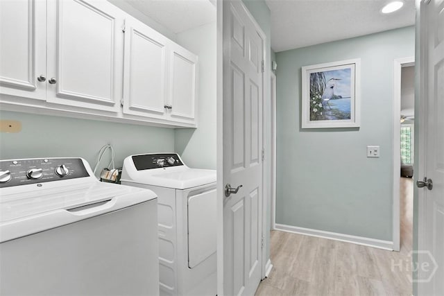 144 Summer Winds Dr, Savannah, GA 31410 - washroom featuring cabinet space, washer and clothes dryer, and light wood-style floors