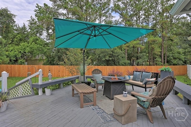 144 Summer Winds Dr, Savannah, GA 31410 - wooden deck featuring a fenced backyard and an outdoor living space with a fire pit