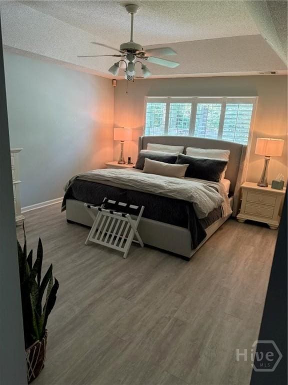 144 Summer Winds Dr, Savannah, GA 31410 - bedroom with a textured ceiling, wood finished floors, and ceiling fan
