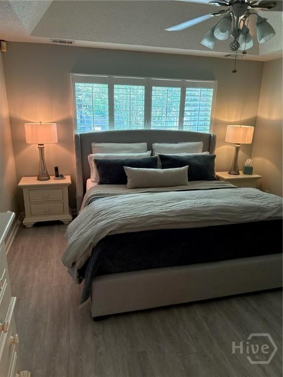 144 Summer Winds Dr, Savannah, GA 31410 - bedroom featuring wood finished floors, multiple windows, and a ceiling fan