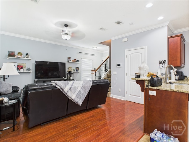 1207 Cypress Fall Cir, Hinesville, GA 31313 - living area featuring dark wood-style floors, crown molding, stairs, a ceiling fan, and recessed lighting