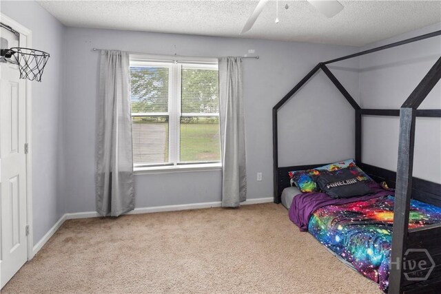 65 Fabian Ln, Hinesville, GA 31313 - carpeted bedroom with a textured ceiling and ceiling fan