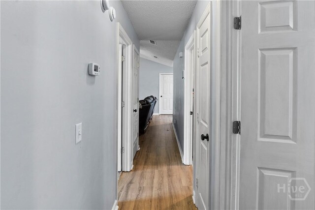 65 Fabian Ln, Hinesville, GA 31313 - hall featuring a textured ceiling and wood finished floors