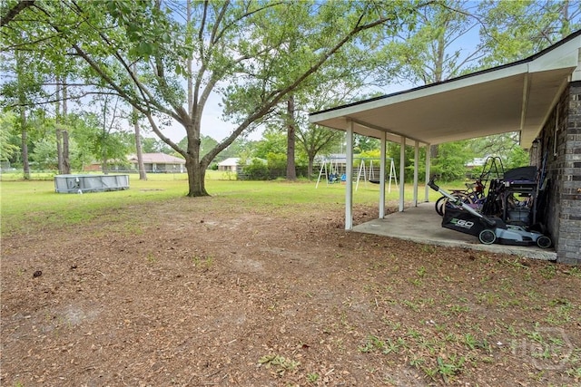 65 Fabian Ln, Hinesville, GA 31313 - view of grassy yard featuring a playground