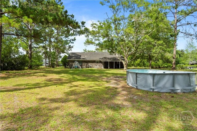 65 Fabian Ln, Hinesville, GA 31313 - view of grassy yard with an outdoor pool