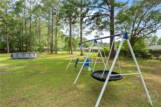 65 Fabian Ln, Hinesville, GA 31313 - view of jungle gym with a lawn and an outdoor pool
