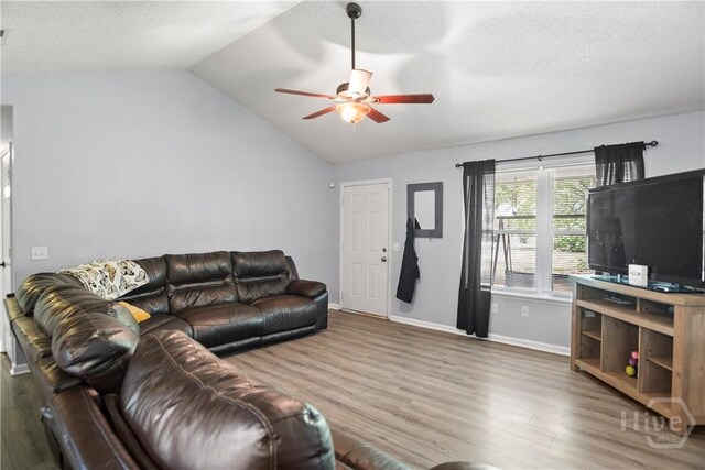 65 Fabian Ln, Hinesville, GA 31313 - living area with wood finished floors, lofted ceiling, ceiling fan, and a textured ceiling