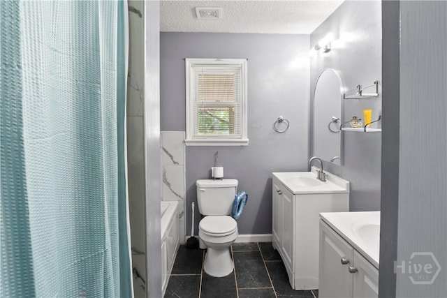 65 Fabian Ln, Hinesville, GA 31313 - bathroom with two vanities, a textured ceiling, and tile patterned floors
