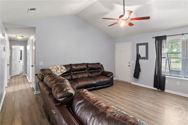 65 Fabian Ln, Hinesville, GA 31313 - living room featuring attic access, wood finished floors, ceiling fan, vaulted ceiling, and a textured ceiling