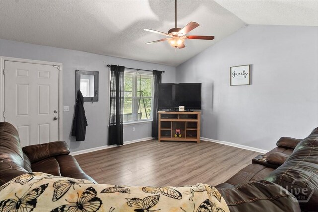65 Fabian Ln, Hinesville, GA 31313 - living room with a ceiling fan, wood finished floors, lofted ceiling, and a textured ceiling