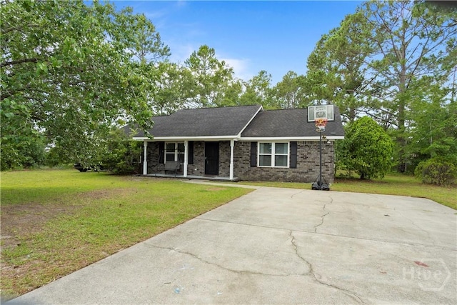 65 Fabian Ln, Hinesville, GA 31313 - view of front of house with covered porch, a front yard, concrete driveway, and brick siding