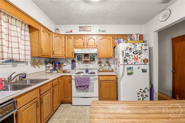 101 Greene Dr, Rincon, GA 31326 - kitchen with white appliances, under cabinet range hood, light countertops, brown cabinets, and a textured ceiling