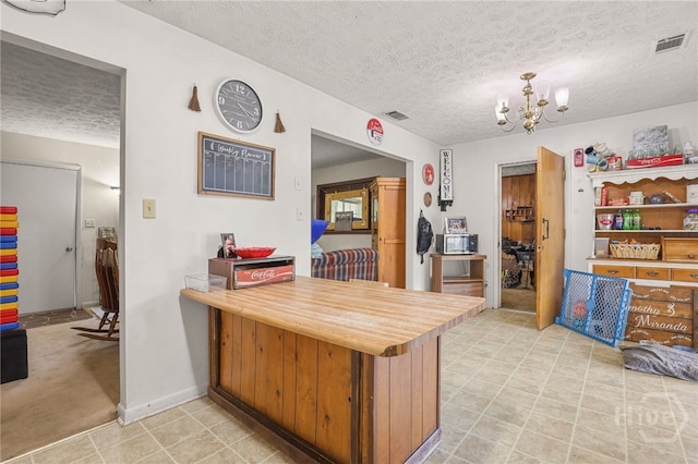 101 Greene Dr, Rincon, GA 31326 - kitchen with a textured ceiling, a chandelier, and a peninsula