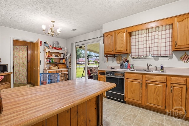 101 Greene Dr, Rincon, GA 31326 - kitchen featuring black appliances, wood counters, a chandelier, brown cabinets, and pendant lighting