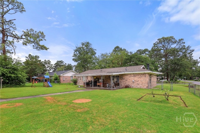 101 Greene Dr, Rincon, GA 31326 - rear view of property with a playground, a patio area, and brick siding