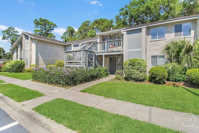 104 Shoals Dr Unit L8, Savannah, GA 31410 - view of front of property featuring a front yard, stairway, and stucco siding