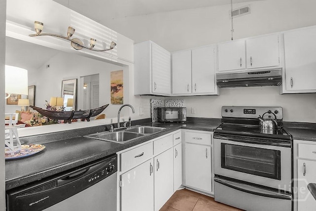 104 Shoals Dr Unit L8, Savannah, GA 31410 - kitchen featuring appliances with stainless steel finishes, under cabinet range hood, dark countertops, white cabinetry, and light tile patterned floors