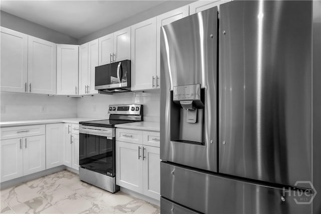 222 N Skinner Ave, Pooler, GA 31322 - kitchen with appliances with stainless steel finishes, light marble finish floors, light countertops, and white cabinetry