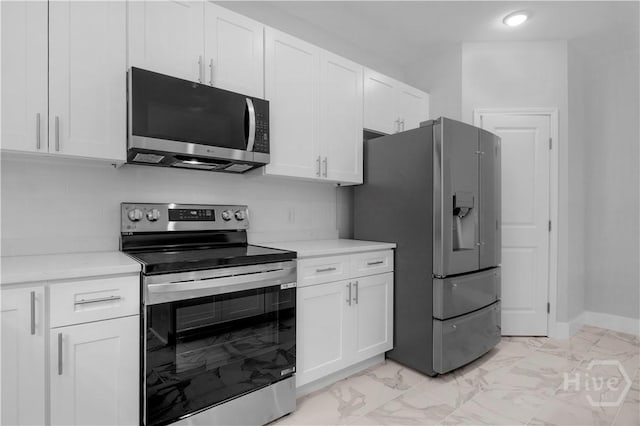 222 N Skinner Ave, Pooler, GA 31322 - kitchen featuring stainless steel appliances, light marble finish flooring, light countertops, and white cabinetry