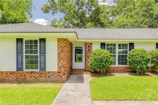 322 Suncrest Blvd, Savannah, GA 31410 - single story home with brick siding, a front yard, and a shingled roof