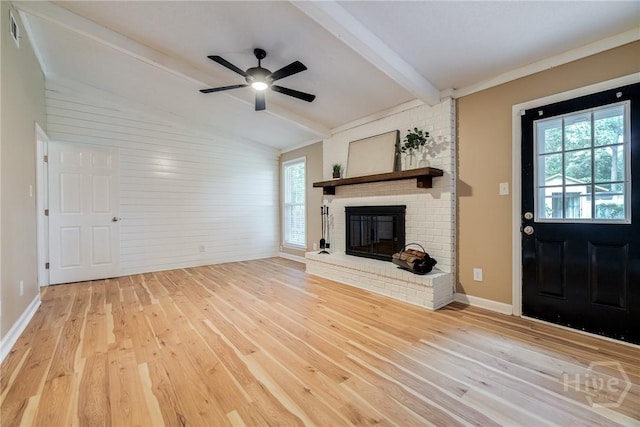 322 Suncrest Blvd, Savannah, GA 31410 - unfurnished living room with wood finished floors, healthy amount of natural light, a ceiling fan, a brick fireplace, and wood walls