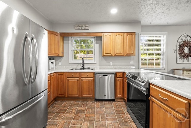 1001 Debbie St, Savannah, GA 31410 - kitchen with stainless steel appliances, healthy amount of natural light, light countertops, brick patterned floors, and a textured ceiling