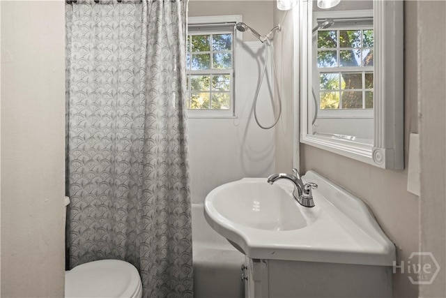 1001 Debbie St, Savannah, GA 31410 - bathroom with healthy amount of natural light, vanity, and shower / bathtub combination with curtain