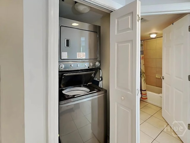 1415 Butler Ave Unit 1, Tybee Island, GA 31328 - washroom with stacked washer and clothes dryer and light tile patterned flooring