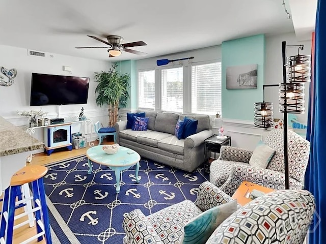 1415 Butler Ave Unit 1, Tybee Island, GA 31328 - living room featuring ceiling fan, a wainscoted wall, and a decorative wall