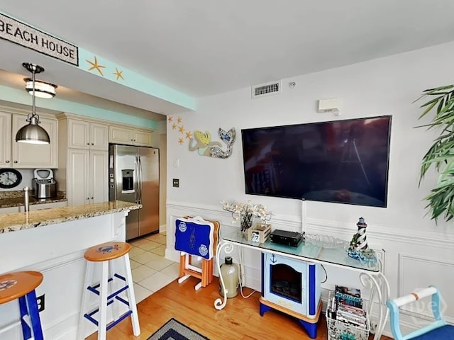 1415 Butler Ave Unit 1, Tybee Island, GA 31328 - living area featuring wainscoting and light wood finished floors