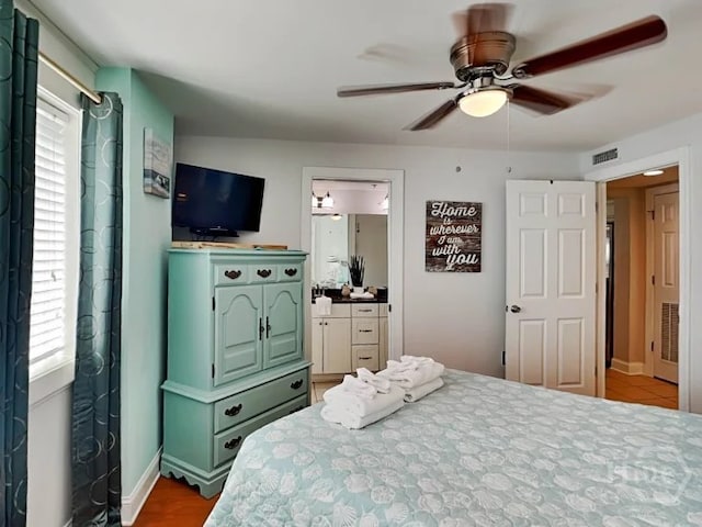1415 Butler Ave Unit 1, Tybee Island, GA 31328 - bedroom with multiple windows, a ceiling fan, and ensuite bathroom