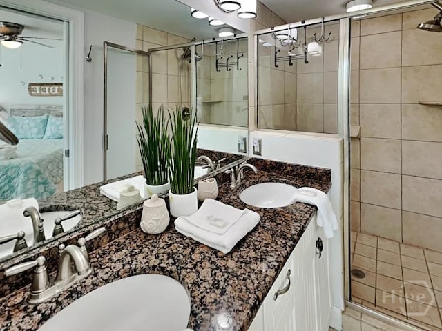 1415 Butler Ave Unit 1, Tybee Island, GA 31328 - full bathroom with ensuite bathroom, double vanity, a shower stall, and a ceiling fan