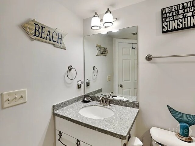 1415 Butler Ave Unit 1, Tybee Island, GA 31328 - half bathroom with vanity and toilet